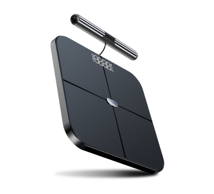 A smart body composition scale featuring a sleek, dark gray or black square platform with rounded corners. The platform is divided into four quadrants by subtle lines, with a circular metallic element in the center
